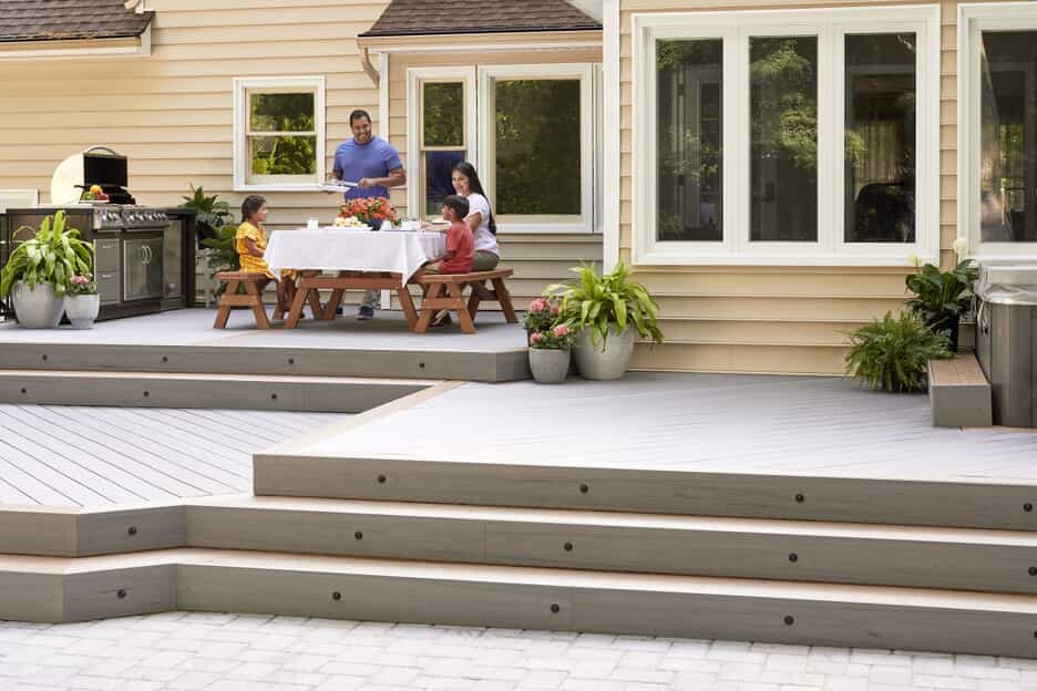 Family sitting on multi level low maintenance deck